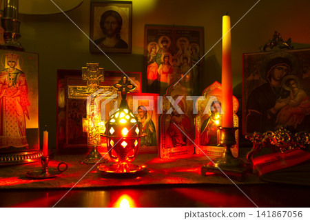 Eastern Orthodox Icons and Candles in a Dark Room Eastern Orthodox Icons and Candles in a Dark Room 141867056