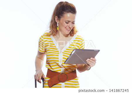 Modern Traveler Reviewing Itinerary on Tablet Device Modern Traveler Reviewing Itinerary on Tablet Device 141867245