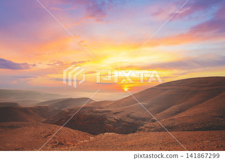 Mountain nature landscape. Desert in early morning. Beautiful sunrise in mountains. Judaean Desert. View of valley with mountains on backdrop. Nature Israel. Mountain nature landscape. Desert in early morning. Beautiful sunrise in mountains. Judaean Desert. View of valley with mountains on backdrop. Nature Israel. 141867299