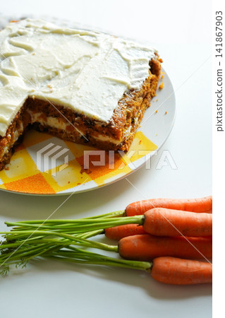 Homemade carrot cake with fresh carrots with leaves on the side. Homemade carrot cake with fresh carrots with leaves on the side. 141867903