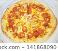A delivery pizza with the box lid opened. 141868090
