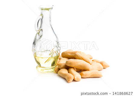 Glass Bottle Of Olive Oil With Italian Taralli Snack On White Background Glass Bottle Of Olive Oil With Italian Taralli Snack On White Background 141868627