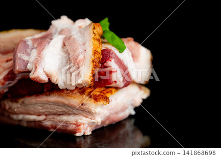 Organic seasoned pork lard with basil garnish on black background Organic seasoned pork lard with basil garnish on black background 141868698