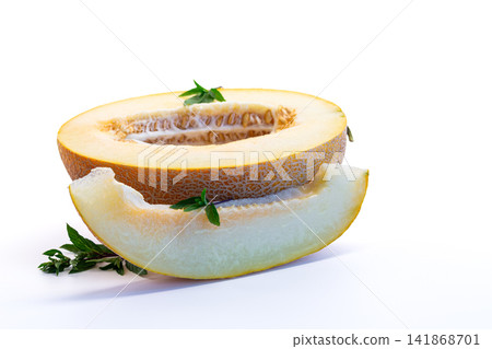 Fresh cantaloupe melon half with basil on white background Fresh cantaloupe melon half with basil on white background 141868701