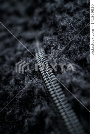 Zipper for clothes black on fleece fabric in macro Zipper for clothes black on fleece fabric in macro 141869030