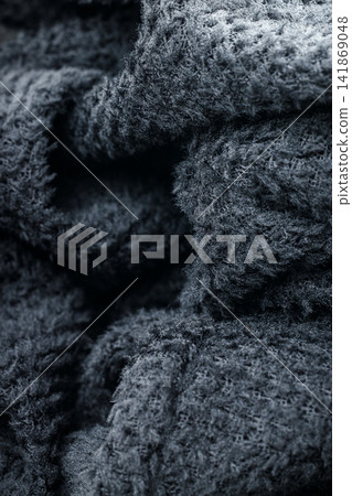 The fabric of black fleece, a synthetic knit with a soft, fluffy texture The fabric of black fleece, a synthetic knit with a soft, fluffy texture 141869048