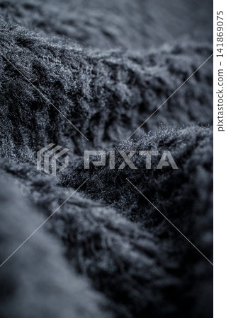 The fabric of black fleece, a synthetic knit with a soft, fluffy texture The fabric of black fleece, a synthetic knit with a soft, fluffy texture 141869075