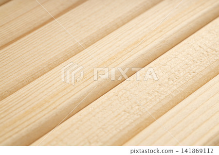 Diagonal slats made of natural wood in warm color Diagonal slats made of natural wood in warm color 141869112