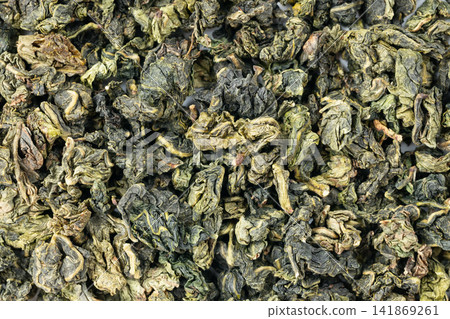 Premium oolong tea leaf background for texture and detail Premium oolong tea leaf background for texture and detail 141869261