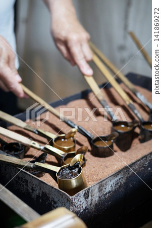 Rustic Turkish coffee ritual cezve brewing over heated sand Rustic Turkish coffee ritual cezve brewing over heated sand 141869272