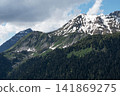 Tranquil Cloudscape Drifting Over Rugged Mountains Tranquil Cloudscape Drifting Over Rugged Mountains 141869275