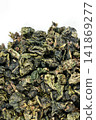 Green oolong tea closeup with white backdrop Green oolong tea closeup with white backdrop 141869277