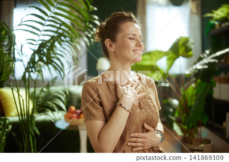 Peaceful Woman Practicing Mindfulness with Plants at Home Peaceful Woman Practicing Mindfulness with Plants at Home 141869309