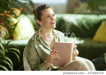 Joyful Woman Enjoying a Good Book at Home Joyful Woman Enjoying a Good Book at Home 141869319