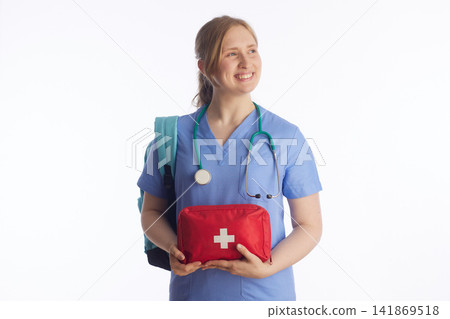Medical Student with First Aid Kit Looking Aside Smiling Medical Student with First Aid Kit Looking Aside Smiling 141869518