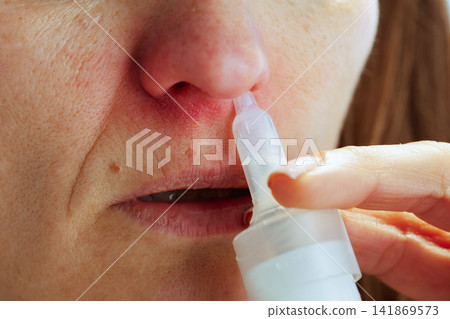 Close-Up of Nasal Spray Application for Cold Relief Close-Up of Nasal Spray Application for Cold Relief 141869573
