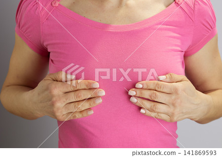 Woman in Pink T-shirt with Hands on Chest for Health Check Woman in Pink T-shirt with Hands on Chest for Health Check 141869593