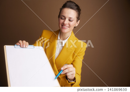 Professional Woman Reviewing Documents on Clipboard Professional Woman Reviewing Documents on Clipboard 141869630