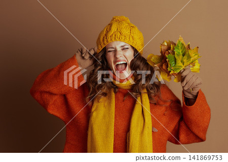 Playful Shout: Woman Reacts to Autumn with Leaves Playful Shout: Woman Reacts to Autumn with Leaves 141869753