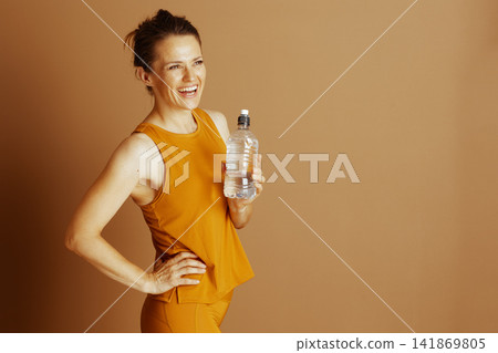 Smiling Woman in Yellow Activewear, Hydrating Smiling Woman in Yellow Activewear, Hydrating 141869805