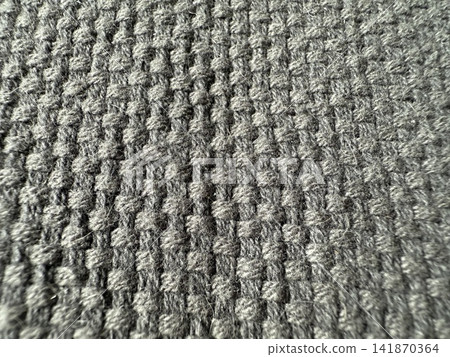 Textured gray fabric in waffle pattern, close-up shot, suitable as background with copy space Textured gray fabric in waffle pattern, close-up shot, suitable as background with copy space 141870364