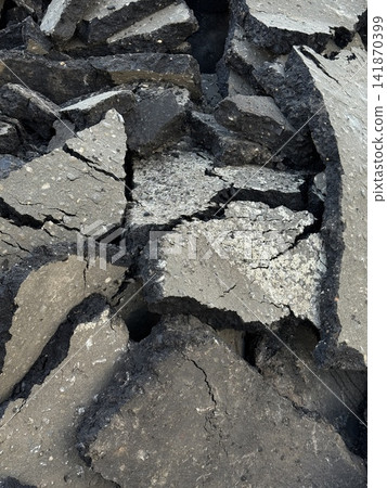 Cracked asphalt pieces arranged in natural broken pattern, ideal for rustic textured background Cracked asphalt pieces arranged in natural broken pattern, ideal for rustic textured background 141870399