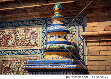 Close up of colorful ceramic tile column head capital at Plaza of Spain in Seville Close up of colorful ceramic tile column head capital at Plaza of Spain in Seville 141870677