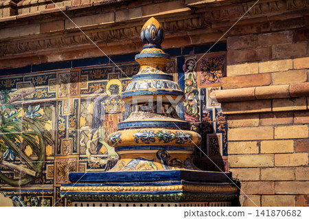 Close up of colorful ceramic tile column head capital at Plaza of Spain in Seville Close up of colorful ceramic tile column head capital at Plaza of Spain in Seville 141870682