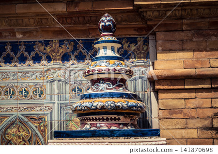 Close up of colorful ceramic tile column head capital at Plaza of Spain in Seville Close up of colorful ceramic tile column head capital at Plaza of Spain in Seville 141870698