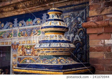 Close up of colorful ceramic tile column head capital at Plaza of Spain in Seville Close up of colorful ceramic tile column head capital at Plaza of Spain in Seville 141870944