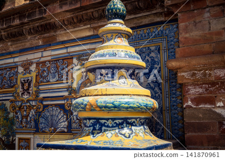 Close up of colorful ceramic tile column head capital at Plaza of Spain in Seville Close up of colorful ceramic tile column head capital at Plaza of Spain in Seville 141870961