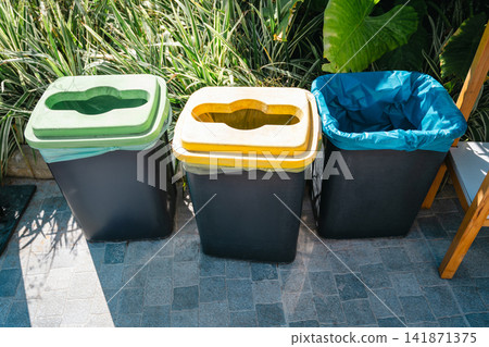 Recycling bins for waste separation outdoors, colorful garbage containers Recycling bins for waste separation outdoors, colorful garbage containers 141871375