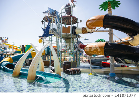 Colourful water park with slides and splash play area at a resort Colourful water park with slides and splash play area at a resort 141871377