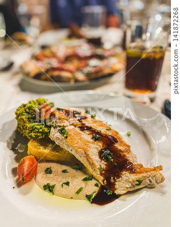 Gourmet Grilled Fish Steak Served with Sauce and Puree in Restaurant Gourmet Grilled Fish Steak Served with Sauce and Puree in Restaurant 141872268