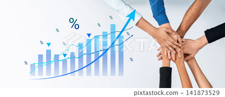 Hands of diverse individuals joining together above a rising graph symbolizing teamwork, growth, collaboration and success in business and finance sectors Cyphers. Hands of diverse individuals joining together above a rising graph symbolizing teamwork, growth, collaboration and success in business and finance sectors Cyphers. 141873529