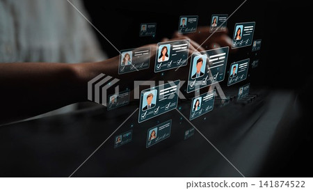 A modern digital interface showcasing virtual profiles and user cards while hands type on a keyboard. The image represents technology, data management, and user engagement concepts. Sigmoid A modern digital interface showcasing virtual profiles and user cards while hands type on a keyboard. The image represents technology, data management, and user engagement concepts. Sigmoid 141874522