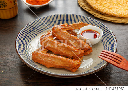 spicy Braised Duck Wings with Chili and Sichuan Pepper 141875081
