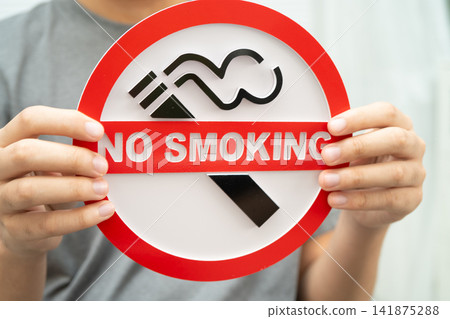Male holding a no smoking sign. Male holding a no smoking sign. 141875288