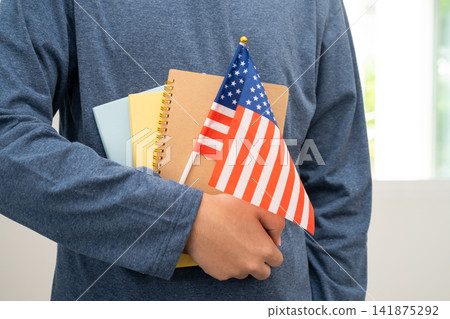 Learn English language, Asian teenage student hold book with flag in course at school. 141875292
