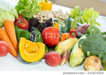 Ingredients: Lots of vegetables placed in the kitchen. Ingredients: Lots of vegetables placed in the kitchen. 141875858