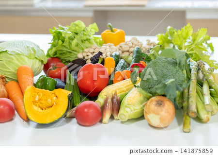 Ingredients: Lots of vegetables placed in the kitchen. Ingredients: Lots of vegetables placed in the kitchen. 141875859