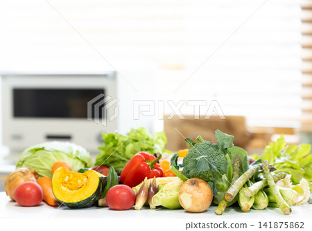 Ingredients: Lots of vegetables placed in the kitchen. Ingredients: Lots of vegetables placed in the kitchen. 141875862