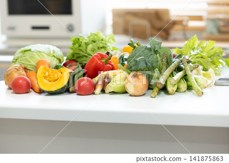 Ingredients: Lots of vegetables placed in the kitchen. Ingredients: Lots of vegetables placed in the kitchen. 141875863
