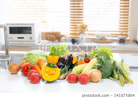 Ingredients: Lots of vegetables placed in the kitchen. Ingredients: Lots of vegetables placed in the kitchen. 141875864