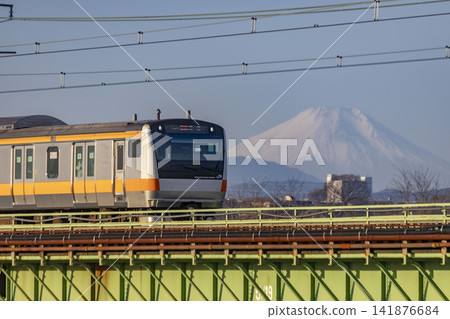 A Chuo Line train crossing the Tamagawa River and Mount Fuji A Chuo Line train crossing the Tamagawa River and Mount Fuji 141876684