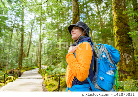 Japanese man hiking in the forest Japanese man hiking in the forest 141876831