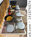 Snack table set on a cozy balcony with chips and appetizers 141876874