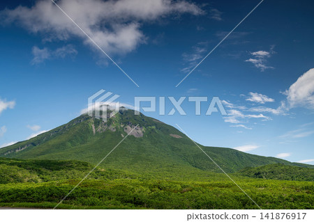 Mount Rausu covered in a lenticular cloud. Mount Rausu covered in a lenticular cloud. 141876917