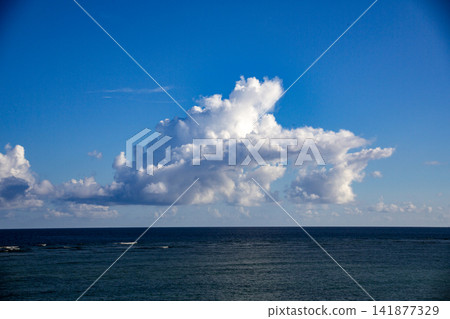 The blue sky and rising white cumulonimbus clouds of Amami Oshima in September. The blue sky and rising white cumulonimbus clouds of Amami Oshima in September. 141877329