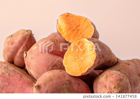 raw red skin sweet potato pile on white background raw red skin sweet potato pile on white background 141877458